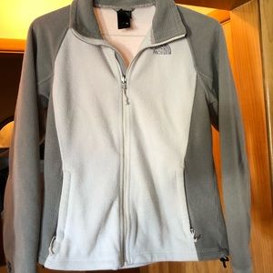 White and gray women’s north face fleece jacket
